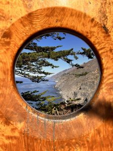 Panoramic view towards the entry of Big Sur through a sculpture hole at Ragged Point, California.
