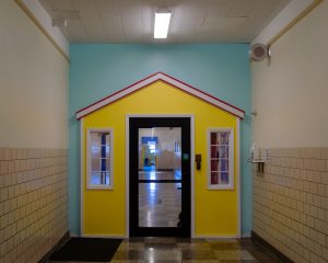 Hallway door decorated with child-sized play house
