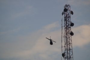 Helicopter passing a tower
