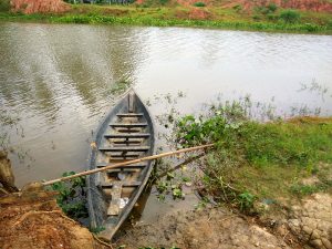 A picturesque small boat on the serene village lake of Bangladesh.

