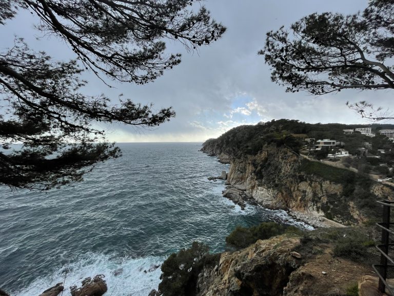 A picture from Tossa de Mar coast, a beautiful village near Girona, Spain.View is from a clifftop looking along the cliff as it goes out into the ocean.