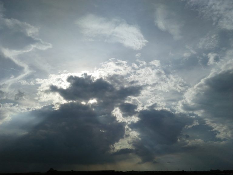 Sunbeams shining through clouds over Dhaka, Bangladesh