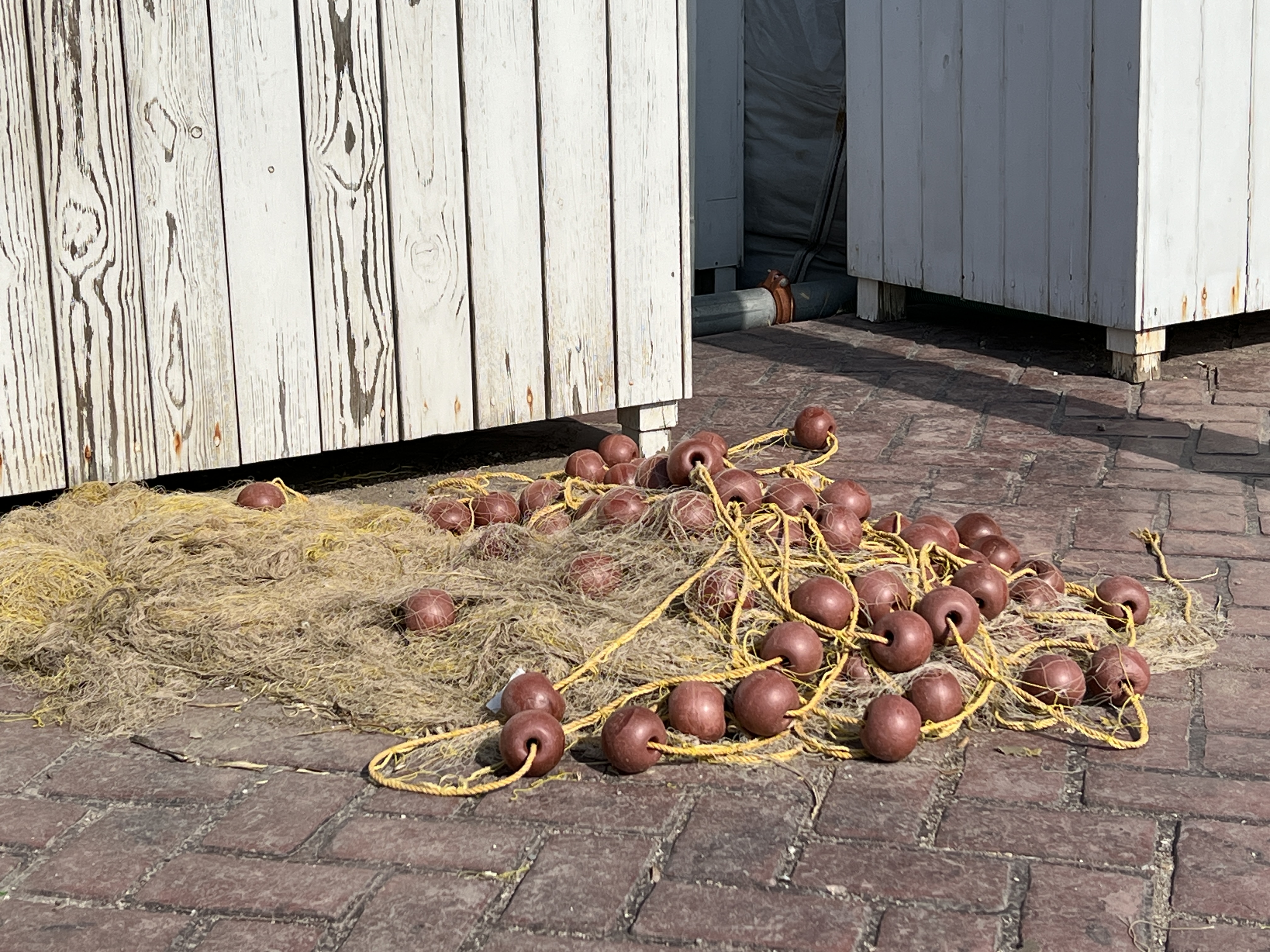 A tangled fishing net lies on the wharf of a fishing village near Athens, Greece. WCEU