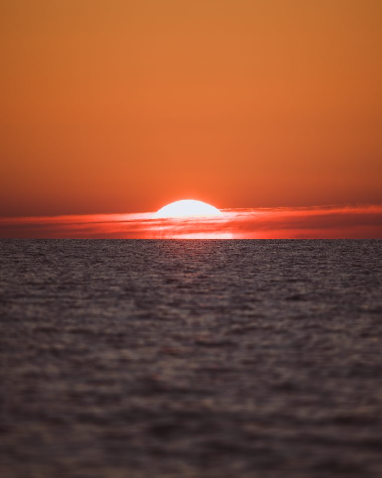 A warm sunset viewed directly on the horizon of the Baltic Sea.