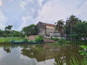 Abandoned Cinema hall and water pond near it.
