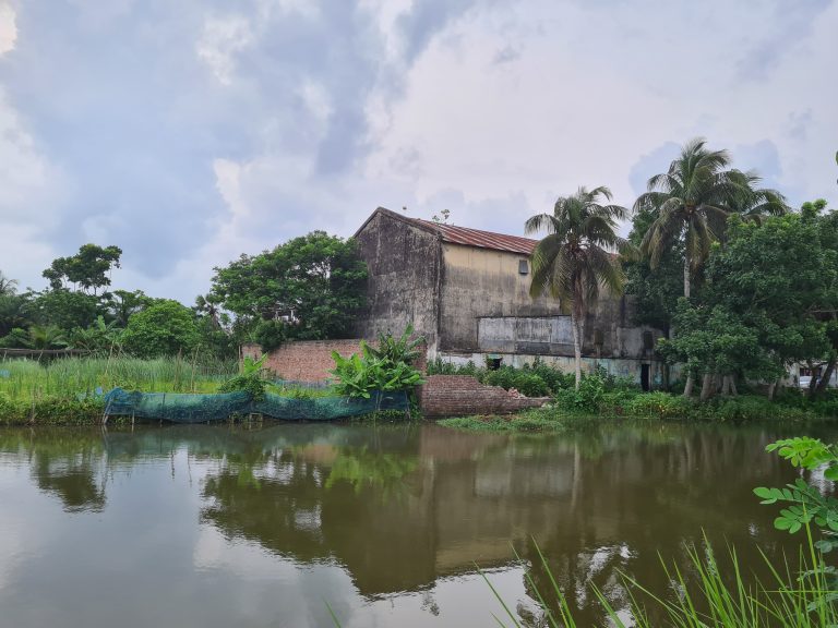 Abandoned Cinema hall and water pond near it.