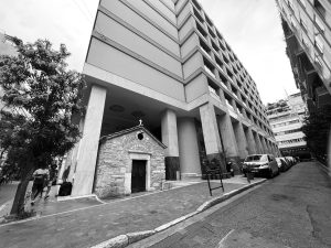 A modern building engulfs an old small chapel in downtown Athens, Greece. WCEU