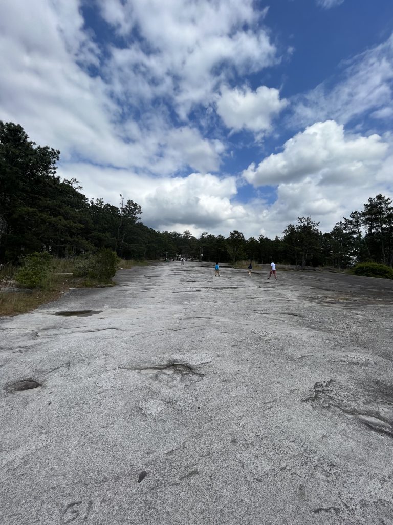 Blue sky clouds grey stone hiking path