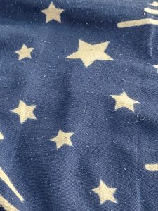 White stars woven into blue fabric.

