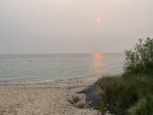 Sunset through haze over Lake Michigan at the beach