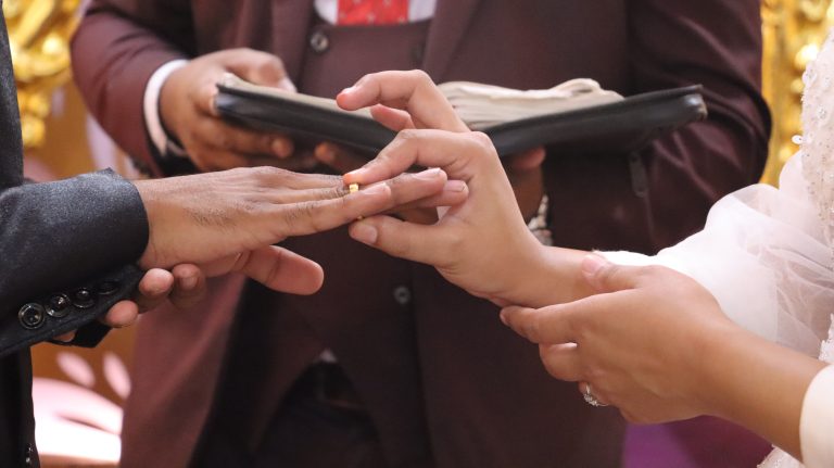 A girl presenting a wedding ring to a boy (Engagement)