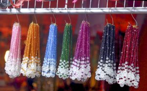 Collections of women’s ornaments hanging in different colors. 

