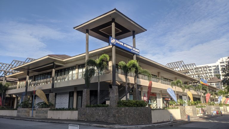 A building with few small trees.