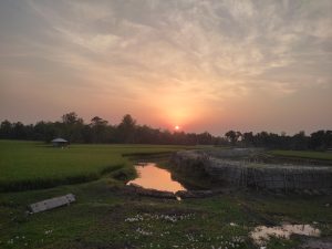  Afternoon view of a field with a water reservoir.
