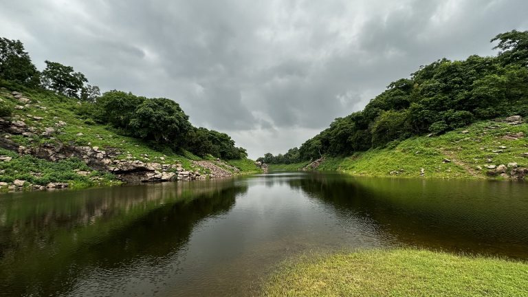 A River in between mountains from two side with beautiful clouds.