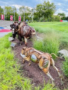 The journey sculpture of National Harbor, Maryland. 

A bull, cow and calf American Bison are on the move across the plains of South Dakota.

By John Lopez Studio. 