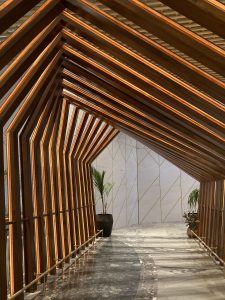 A beautiful balcony structure made with wood with is golden polished at the Airport Lounge of Bengaluru.