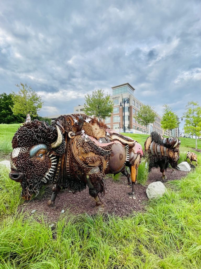 The journey sculpture of National Harbor, Maryland. A bull, cow and calf American Bison are on the move across the plains of South Dakota. By John Lopez Studio.