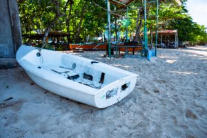 Abandoned white boat at the beach