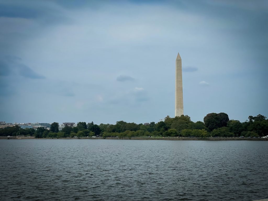 The Washington Monument with a body of water in front of it.
