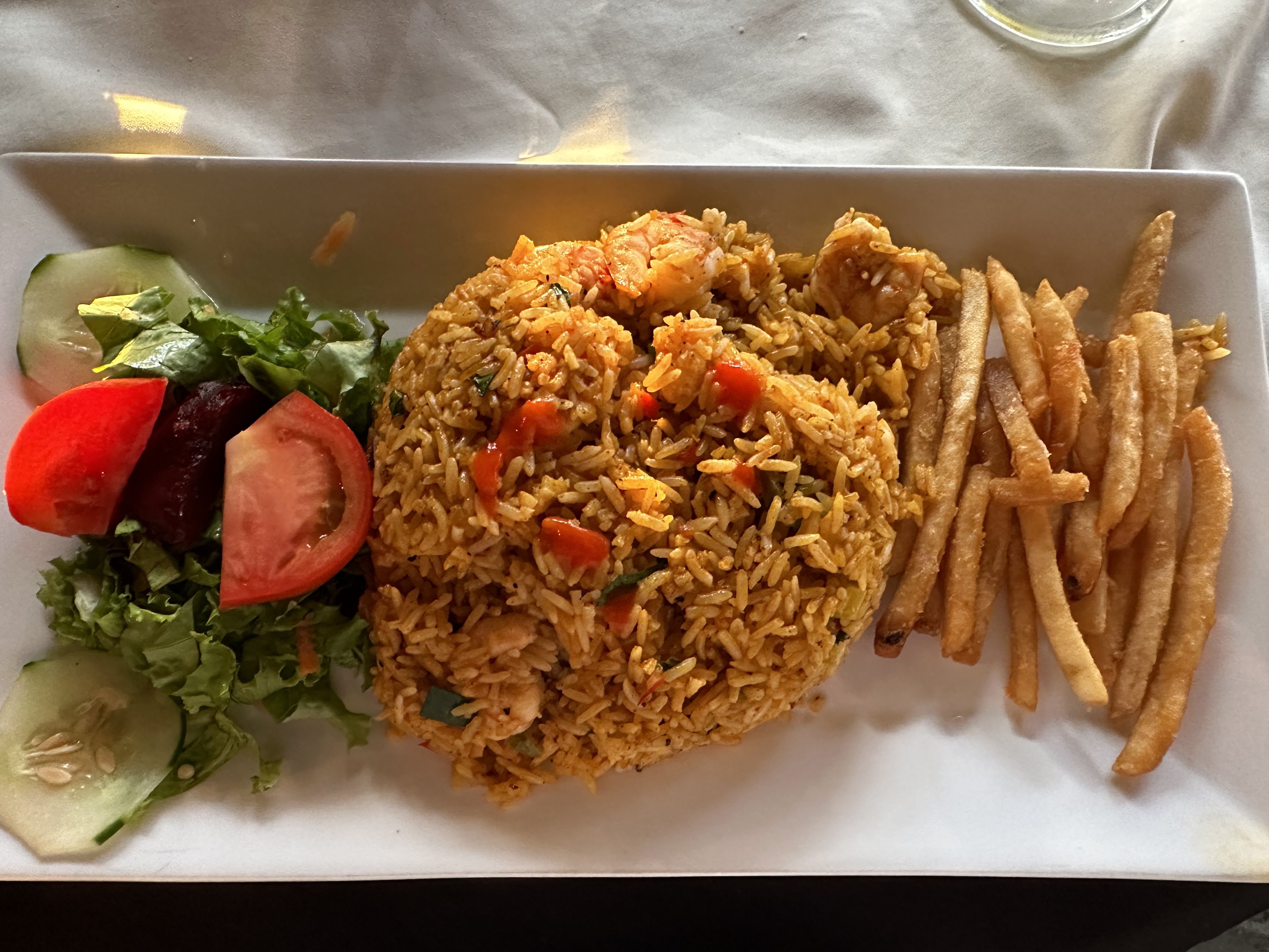 Rice with shrimp, salad and french fries in a Central Pacific restaurant in Costa Rica.