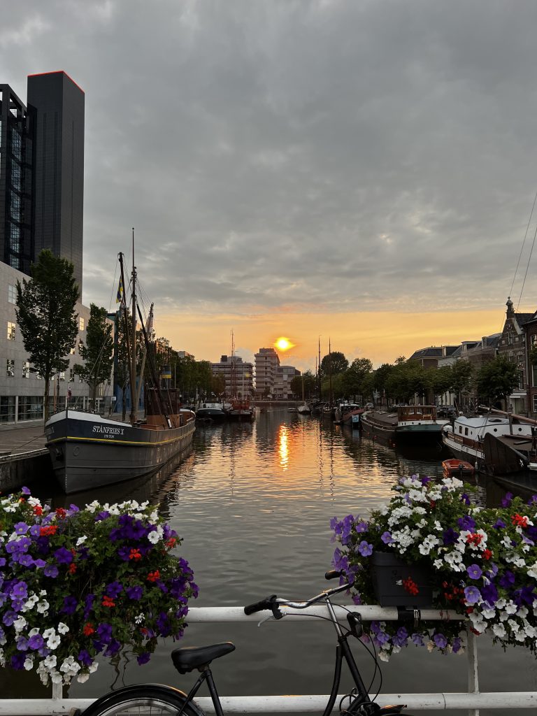 Sunset over a beautiful canal full of historical boats in the Dutch city Leeuwarden (or Ljouwert)