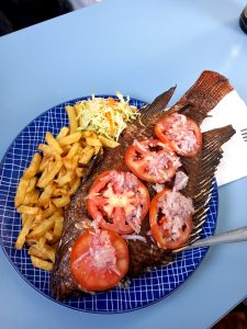 A plate of fries and tilapia from Lake Victoria served during ferry ride