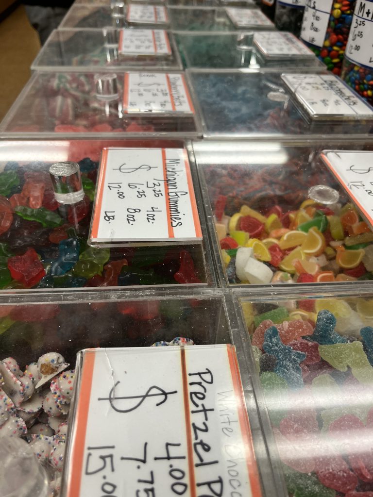 A row of candy bins in a candy store.