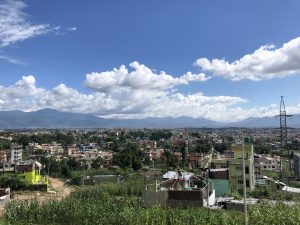 View larger photo: A small part of Kathmandu when the sky is clear. A long view over the city roofs to mountains in the distance.