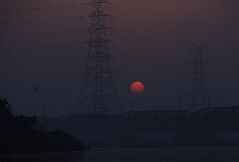 A perfect sunrise in between the electricity poles.