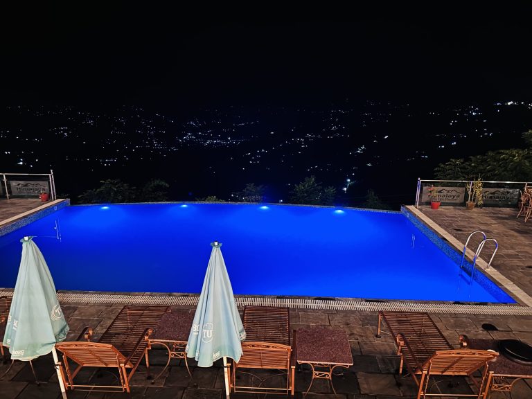 Night view of the city from a swimming pool.