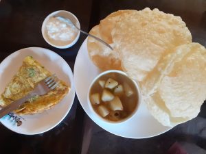 A traditional Bengali breakfast includes Omelet and Potato. 