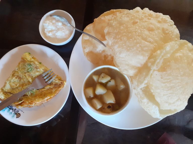 A traditional Bengali breakfast includes Omelet and Potato.