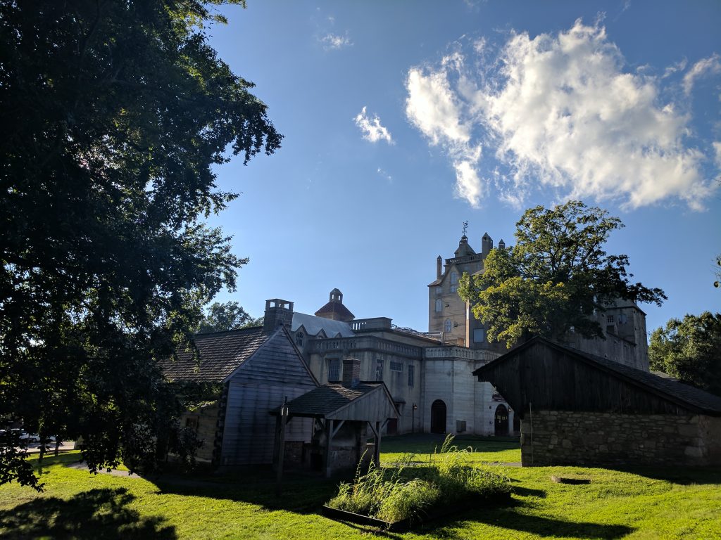 Mercer Museum in Doylestown, Bucks County Pennsylvania. A sunny day with blue skies. Trees have leaves on them.