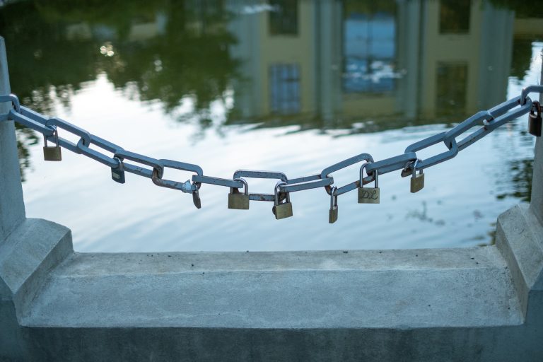 Lock and chain with water in the background.