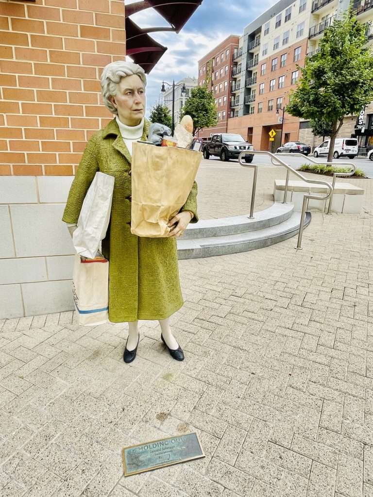 The Holding Out statue by Seward Johnson. From National Harbor, Maryland, United States.