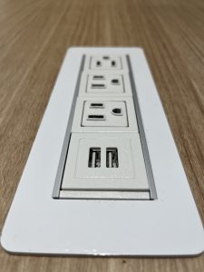 Row of American style power outlets that look like faces being dismayed.
