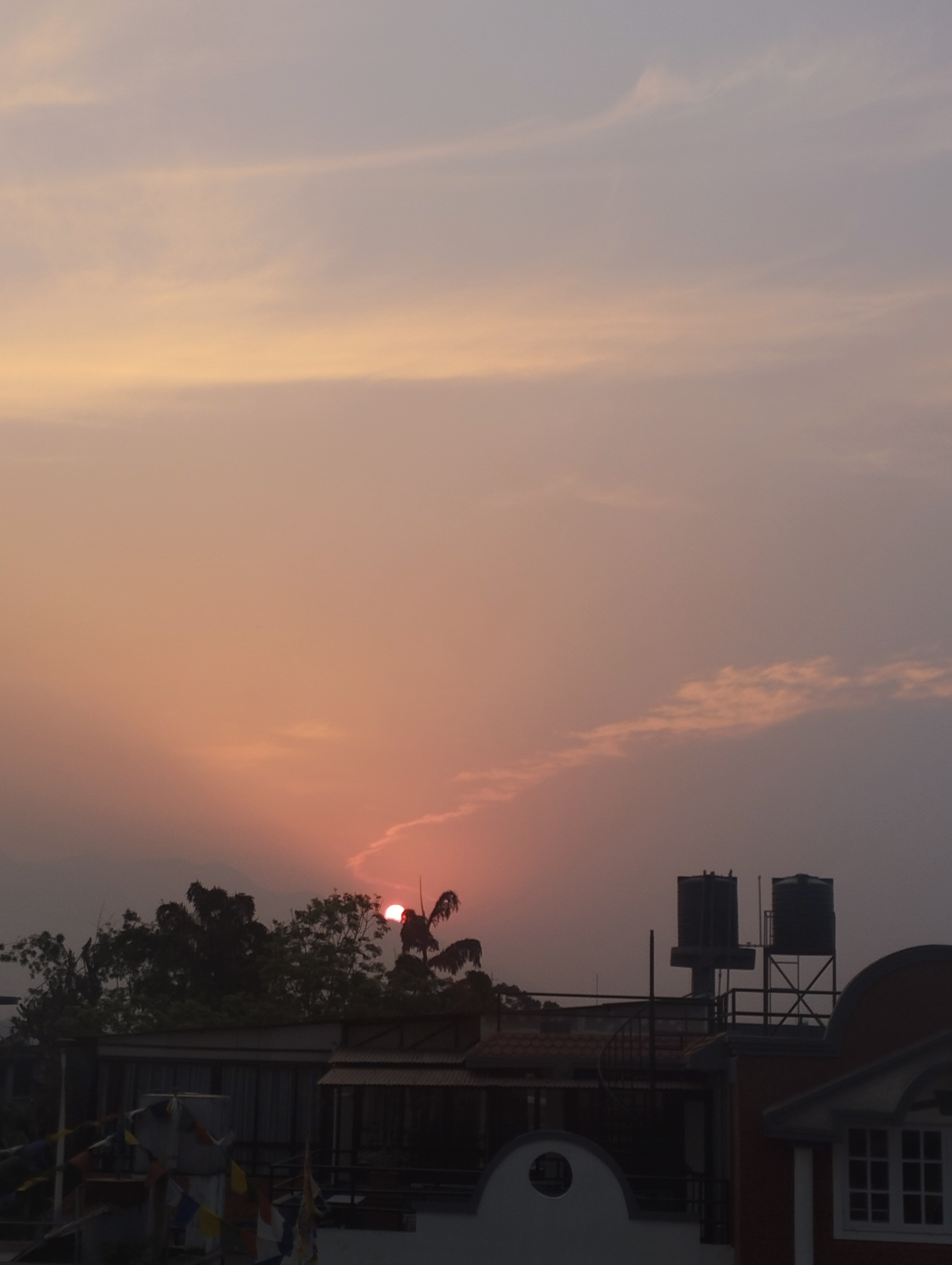 sunset with a house in the background