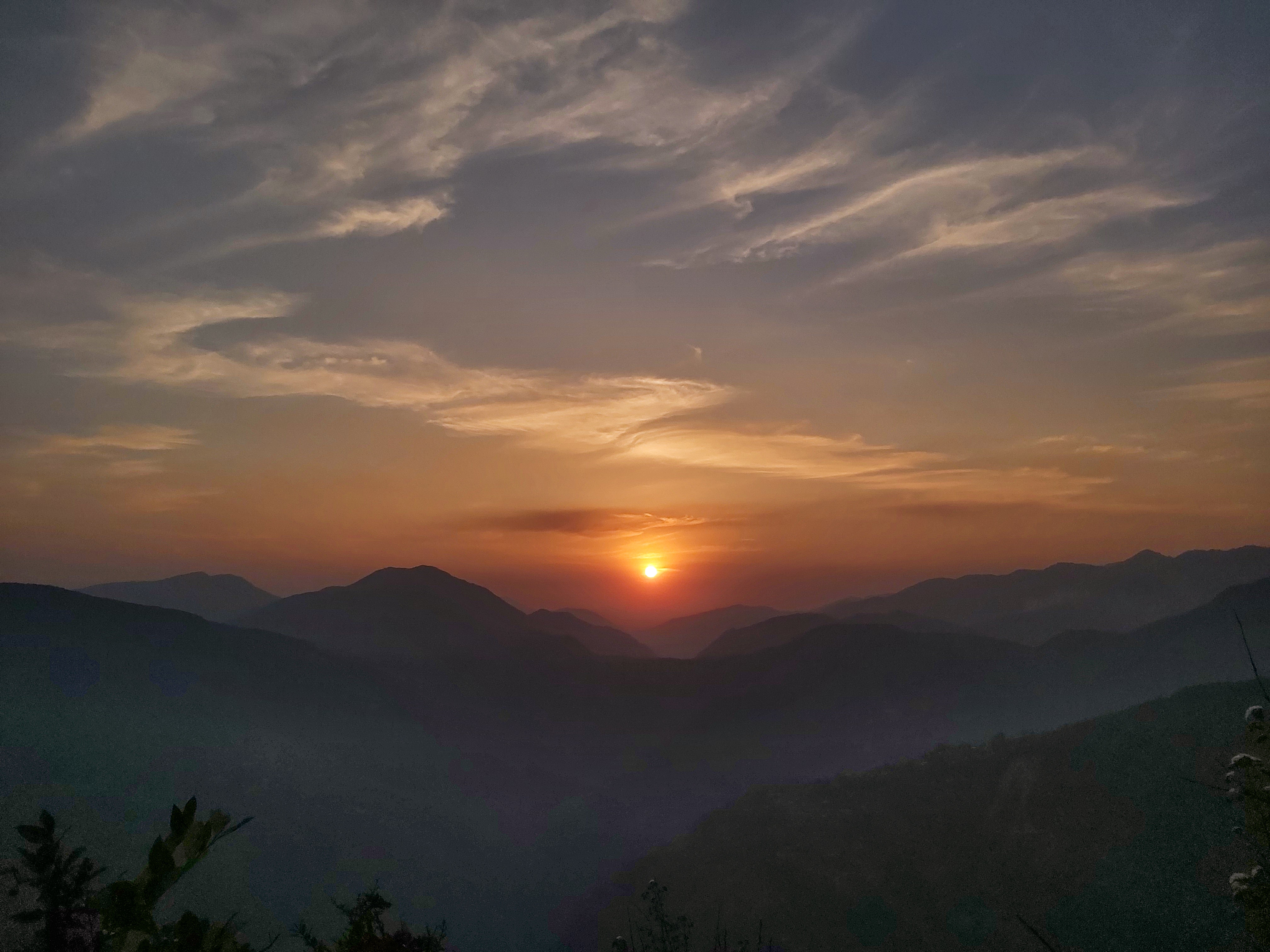 sunset with mountains in the background