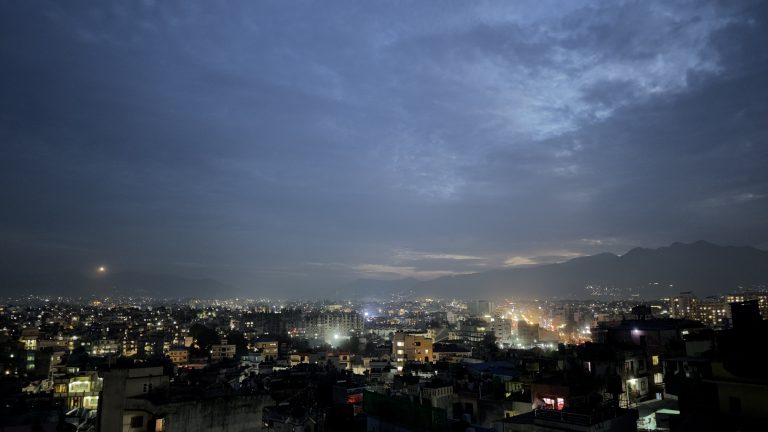 Kathmandu, Nepal, night time view with the city lights on and mountains beyond the city