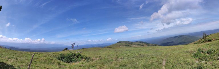 Panoramic view of the cloudy blue sky and green valley from Gopalswami hills near Gundulpet of Karnataka state, India