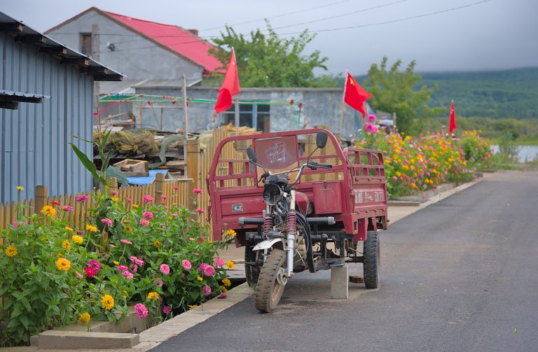 A broken tricycle in a Chinese village.