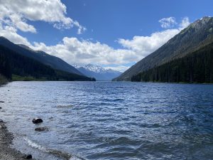 A lake with snow-capped mountains in the background