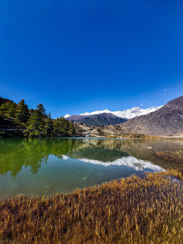 Lake, mountain with snow and a clear sky view.