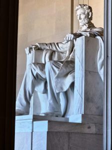 A different angle of the Abraham Lincoln statue through the gigantic pillars of the Lincoln Memorial. From Washington DC, United States. 