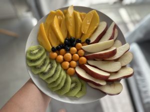 A full plates of fruits including Mango, Apple, Kiwi, Blueberry, Golden berry, Cartago, Costa Rica.

