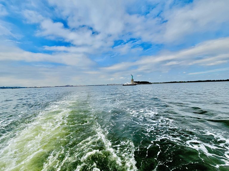 Very long view of Statue of Liberty from Hudson River. New York, United States