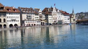 The town of Lucerne, Switzerland, looking upon river side cafés taken from the Chapel Bridge