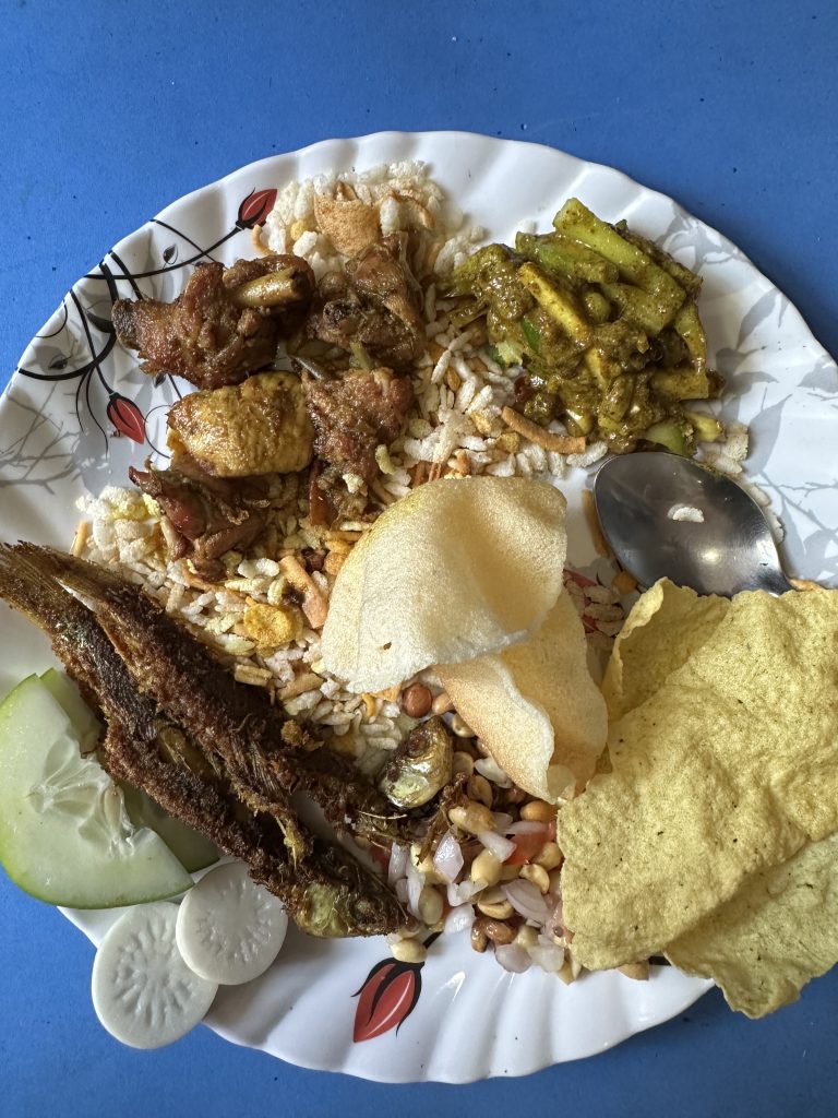 Snacks set consisting of Furandana, fish fry, chicken fry, cucumber, radish, papad, fried prawn cracker, and pickle. This type of snacks are most popular in Newari community.