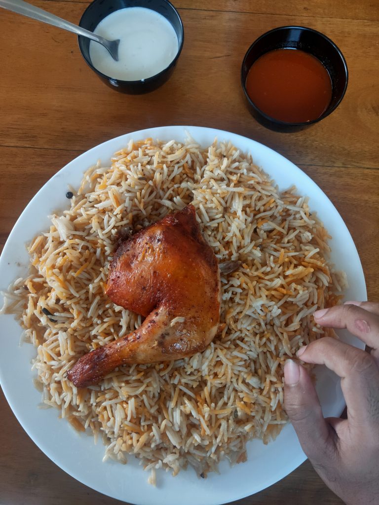 kuzhimandhi, a dish of rice and chicken with sauces.